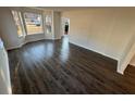 Bright living room featuring new wood floors and large windows for natural light at 3689 Deer Springs Trl, Ellenwood, GA 30294