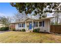 Inviting single-story home with a covered carport, blue shutters, manicured landscaping, and a welcoming entrance at 3351 Creatwood Se Trl, Smyrna, GA 30080