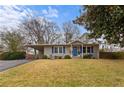 Charming single story home with blue door, blue shutters, carport and manicured front lawn at 3351 Creatwood Se Trl, Smyrna, GA 30080