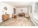 Bright living room with neutral-toned furniture, new floors, and natural light from large windows at 4324 Rue Saint Michel, Stone Mountain, GA 30083