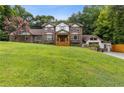 Elegant two-story brick home with a manicured lawn and inviting front entrance at 3996 Spalding Ln, Atlanta, GA 30350
