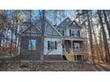 Inviting two-story home featuring stone accents and a cozy front porch at 488 Morris Rd, Hiram, GA 30141