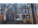 Inviting two-story home with a covered front porch and mature trees at 488 Morris Rd, Hiram, GA 30141