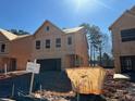 New construction home exterior featuring a two-car garage in a sunny neighborhood at 1238 Riverstone Rd, Jonesboro, GA 30238