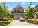 Charming two-story brick home with two-car garage, brown shutters, a driveway, and a well-manicured front yard at 1749 Charcoal Ives Rd, Lawrenceville, GA 30045