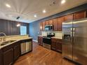 Modern kitchen featuring stainless steel appliances, granite countertops, ample cabinet space, and a breakfast bar at 1749 Charcoal Ives Rd, Lawrenceville, GA 30045