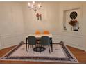 Cozy dining area with chandelier, modern table set and decorative wall niche at 3893 Dandridge Way, Duluth, GA 30096