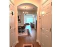 Inviting entryway with hardwood floors leading to the dining and living areas with chandelier at 3893 Dandridge Way, Duluth, GA 30096