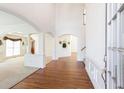 Bright foyer featuring hardwood floors, arched doorways, and white trim, leading to formal spaces at 2322 Norbury Se Cv, Smyrna, GA 30080