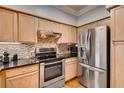Modern kitchen with stainless steel appliances, granite countertops, and well-lit cabinetry at 3777 Peachtree Ne Rd # 1324, Brookhaven, GA 30319