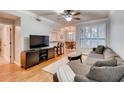 A spacious living room with modern furniture, hardwood floors, and ample natural light through plantation shutters at 3777 Peachtree Ne Rd # 1324, Brookhaven, GA 30319