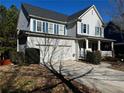 Well-manicured two-story home with attached two car garage and inviting front porch at 9137 Loxford St, Lithia Springs, GA 30122