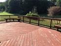 A red wooden deck features built-in seating and a railing at 2500 Woodward Rd, Atlanta, GA 30349