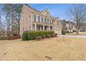 Well-maintained two-story brick home with blue shutters, manicured lawn, and attached two-car garage at 3739 Newhalem Sw St, Atlanta, GA 30331