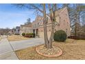 Two-story brick home with attached two-car garage, showcasing a well-kept lawn and landscaping at 3739 Newhalem Sw St, Atlanta, GA 30331