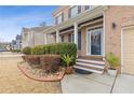 Inviting front porch of a brick home, featuring a decorated door and manicured landscaping at 3739 Newhalem Sw St, Atlanta, GA 30331