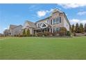 Lovely front yard with manicured lawn and an inviting stone and siding facade at 4681 Gablestone Dr, Hoschton, GA 30548