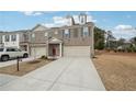 Charming two-story townhome with attached garage and well-manicured lawn at 2865 Port Bow Ln, Cumming, GA 30041