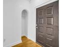 View of entryway with hardwood flooring, an arched alcove, and a dark wooden door at 821 Ralph Mcgill Ne Blvd # 3104, Atlanta, GA 30306