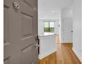 Inviting entryway featuring hardwood floors, white walls, and a glimpse into the open-concept living space at 821 Ralph Mcgill Ne Blvd # 3104, Atlanta, GA 30306
