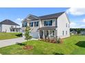 Charming two-story home boasts a well-maintained lawn and inviting curb appeal at 1049 Blue Juniper Cir, Loganville, GA 30052