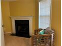 Cozy living room featuring a fireplace, light wood flooring, and bright natural light from a sliding glass door at 4620 Grand Central Pkwy, Decatur, GA 30035