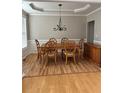 Elegant dining room with hardwood floors, tray ceiling, and classic chandelier, ideal for formal gatherings at 3305 Wickum Sw Rd, Atlanta, GA 30349