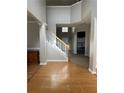 Inviting foyer with hardwood floors, staircase, and high ceilings, creating an open and airy entrance at 3305 Wickum Sw Rd, Atlanta, GA 30349
