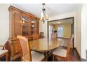 Elegant dining room featuring a glass table, and an antique china cabinet at 664 Church Nw St, Atlanta, GA 30318