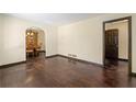 Spacious living room with gleaming hardwood floors and an archway leading to the dining area at 664 Church Nw St, Atlanta, GA 30318