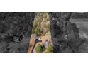 Aerial view of the property showing the house, driveway, outbuildings and surrounding trees at 583 Mount Zion Rd, Oxford, GA 30054