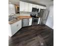 Bright kitchen with white cabinets, butcher block countertops, and stainless steel appliances at 814 Humphries Sw St, Atlanta, GA 30310