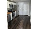 Updated kitchen with stainless steel appliances, butcher block countertops, and modern finishes at 814 Humphries Sw St, Atlanta, GA 30310