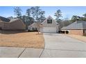 Beautiful brick single-story home with a two-car garage and a long concrete driveway at 106 Saint Margrit Cir, Stockbridge, GA 30281