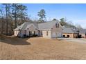 Attractive single-story brick home with a well-manicured lawn and an attached two-car garage at 106 Saint Margrit Cir, Stockbridge, GA 30281