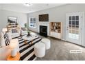 Bright, staged living room with a fireplace, comfortable seating, and stylish decor at 2928 Lakewater Way, Snellville, GA 30039