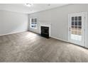 Bright living room with a fireplace and a door leading to the backyard at 2928 Lakewater Way, Snellville, GA 30039
