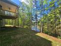 Scenic backyard with a wooden deck overlooking a peaceful, wooded area and waterway at 3687 Thornhill Ct, Douglasville, GA 30135