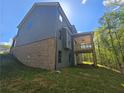 View of a backyard featuring a wooden deck attached to a home with gray siding at 3687 Thornhill Ct, Douglasville, GA 30135