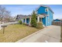 View of the home's blue siding, front yard, mailbox, and a concrete driveway to the rear at 1598 Jonesboro Se Rd, Atlanta, GA 30315