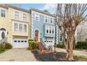 Townhome exterior showcasing a quaint front patio, attached garage, and well-manicured landscaping at 3783 Meeting St, Duluth, GA 30096