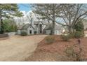 Beautiful home with mature trees, stone accents, and a two-car garage at 10640 Branham Fields Rd, Johns Creek, GA 30097
