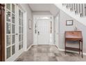Welcoming foyer with tile flooring, staircase, and elegant decor at 10640 Branham Fields Rd, Johns Creek, GA 30097