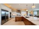 Spacious kitchen with white cabinets, stainless steel appliances, a marble countertop island, and modern lighting at 362 Old Ivy Ne Rd, Atlanta, GA 30342