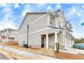 Side view of a well-maintained townhome with a charming entrance and two-car garage at 539 Walton Dr, Woodstock, GA 30188