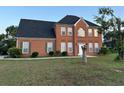 Charming brick two-story home featuring a manicured front lawn and trimmed shrubs at 3305 Wolverton Sw Ct, Conyers, GA 30094