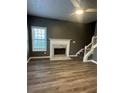 Inviting living room with hardwood floors, fireplace, ceiling fan, and stairway at 3305 Wolverton Sw Ct, Conyers, GA 30094