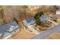 Aerial view of a traditional home with mature trees in a well-maintained neighborhood at 1657 Stilesboro Ridge Dr, Kennesaw, GA 30152