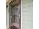 Close-up of unit door, dark frame, pane glass with matching handle, and green siding at 3205 Canyon Point Cir, Roswell, GA 30076