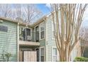 Balcony view with black railing on a condo featuring green siding and well-maintained landscaping at 3205 Canyon Point Cir, Roswell, GA 30076